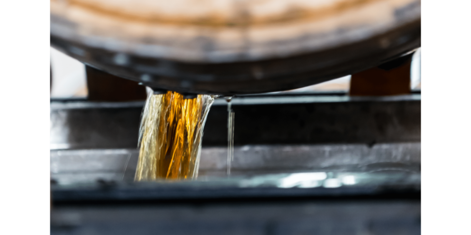 bourbon pouring out of a barrel