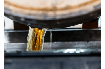 bourbon pouring out of a barrel